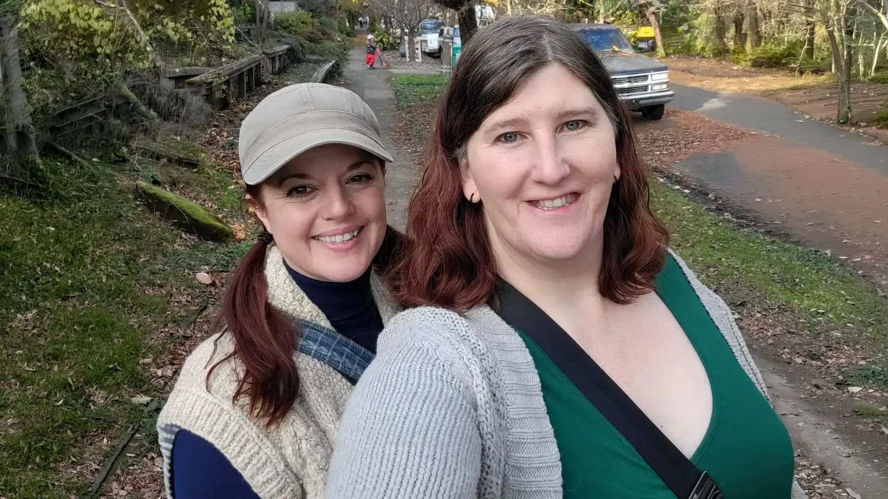 Morgan and Mackenzie together on a leafy neighborhood sidewalk in Portland.